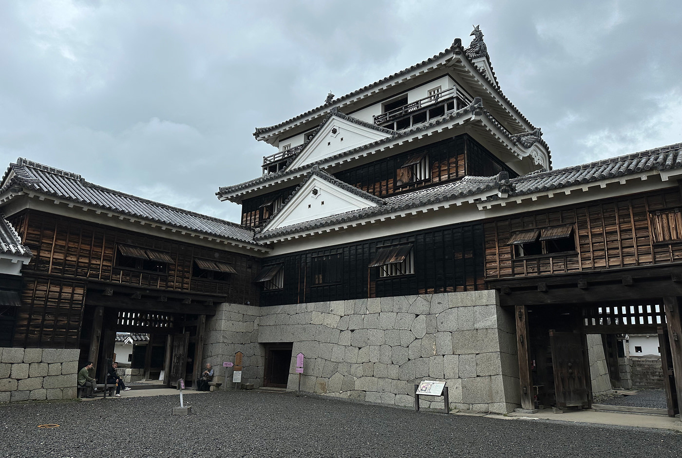 Innergård till tornet på Matsuyama Castle. Gruset på innergården är märkt. Portar till resten av området finns på höger och vänster sida.